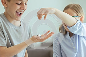 Two happy children playing with dices and laughing