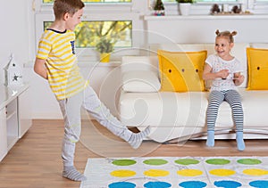 Two happy children playing exciting game at home