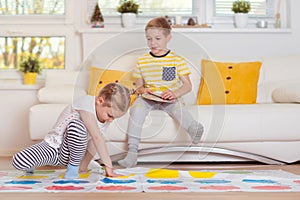 Two happy children playing exciting game at home