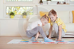 Two happy children playing exciting game at home