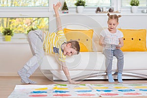 Two happy children playing exciting game at home