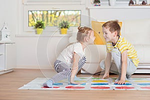 Two happy children playing exciting game at home