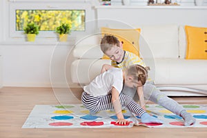 Two happy children playing exciting game at home