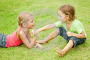 Two happy children playing on the grass