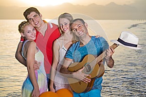 Two Happy Couples at the Beach on Sunset.