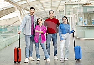 Two Happy Couples Friends Posing With Luggage Standing In Airport