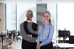 Two happy diverse professional executive business team people woman and African American man looking at camera standing