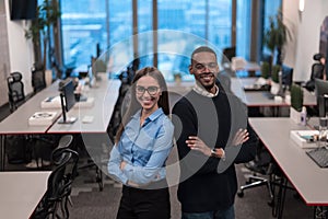 Two happy diverse professional executive business team people woman and African American man looking at camera standing