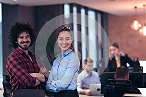 Two happy diverse professional executive business team people woman and man looking at camera standing in office lobby