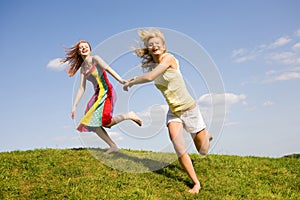 Two happy girls jumping