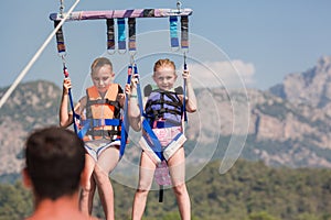 Two happy girls parasailing