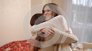 Two happy girls smiling and hugging after hugging