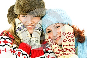 Two happy girls wearing warm winter clothes