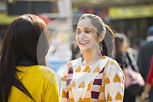 Two women having fun at Surajkund Mela photo