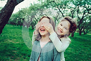 Two happy kid girl playing together in summer, outdoor activities