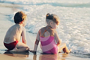 Two happy kids playing on the beach