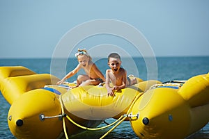 Two happy kids playing on the boat at summer day