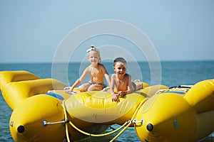 Two happy kids playing on the boat at summer day