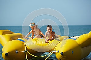 Two happy kids playing on the boat at summer day