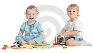 Two happy kids playing logical toys