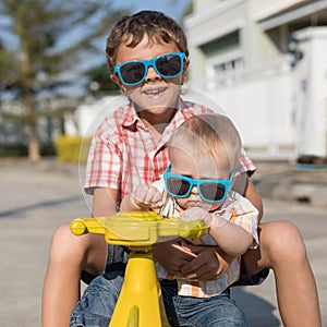 Two happy little children playing on the road at the day time