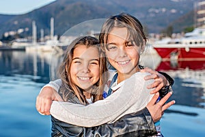 Two happy little girl smiling and looking at the camera