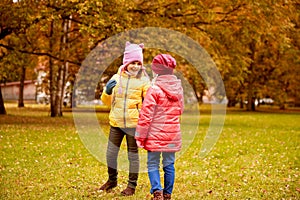 Two happy little girls in autumn park