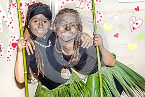 Two happy little girls dressed in african tribe costumes for mas