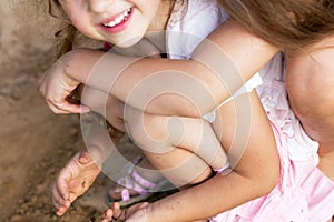 Two Happy little girls laughing and embracing at the summer par