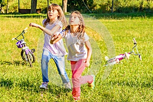 Two happy little girls playing in the park