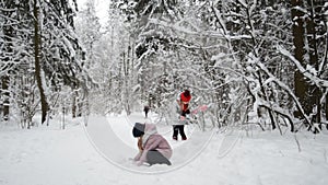 Two happy little girls playing with snow
