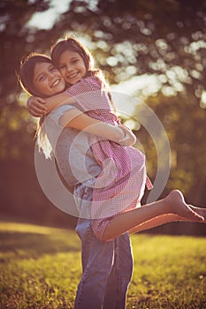 Two happy little girls playing together in nature.