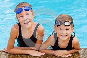 Two happy little girls in the pool