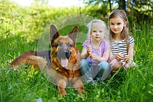 Two happy little girls and their big dog