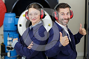 Two happy mechanics looking to camera