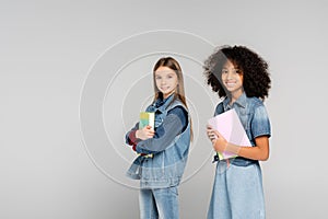 two happy multicultural schoolkids in denim