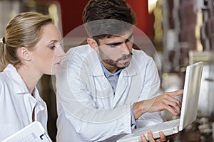 two happy researchers in labcoats