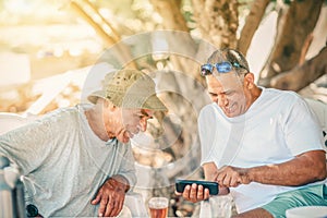 Two Happy Senior Men Baby Boomers Friends Having Fun Use Smart Phone. Active And Healthy Lifestyle.