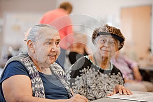 Two Happy Senior Woman seated at table