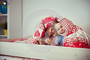 Two happy sibling children having fun in bunk bed