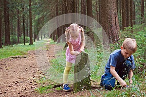 Two happy siblings playing in forest