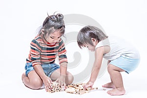 Two happy siblings playing with wooden box