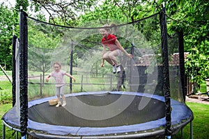 Two happy sisters on trampoline