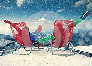 Two happy skiers on the top of mountain