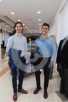 Two Happy Smiling Businessmen Wearing Elegant Suits Full Length Male Standing In Modern Menswear Retail Store