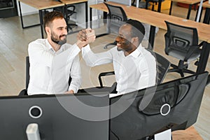 Two happy successful excited diverse traders investors giving high five celebrating successful stock exchange trading