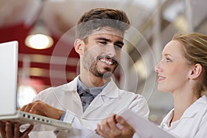 two happy technicians using laptop