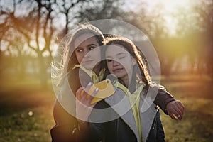 Two happy teenage girls friends using on mobile phone