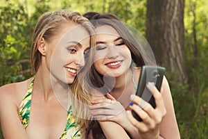 Two happy teenage girls taking selfshot or selfy picture of them