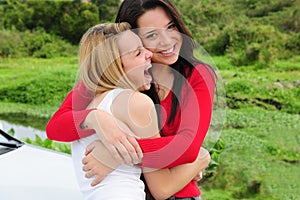 Two happy women on car trip